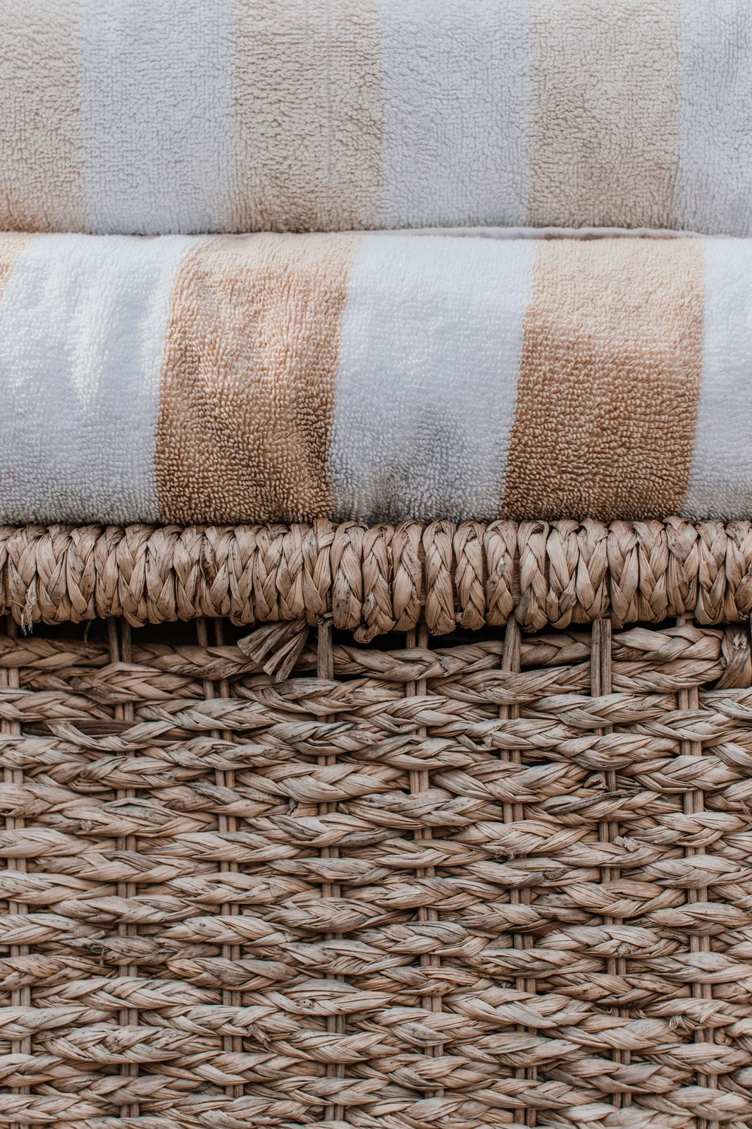 Folded towels on a woven basket