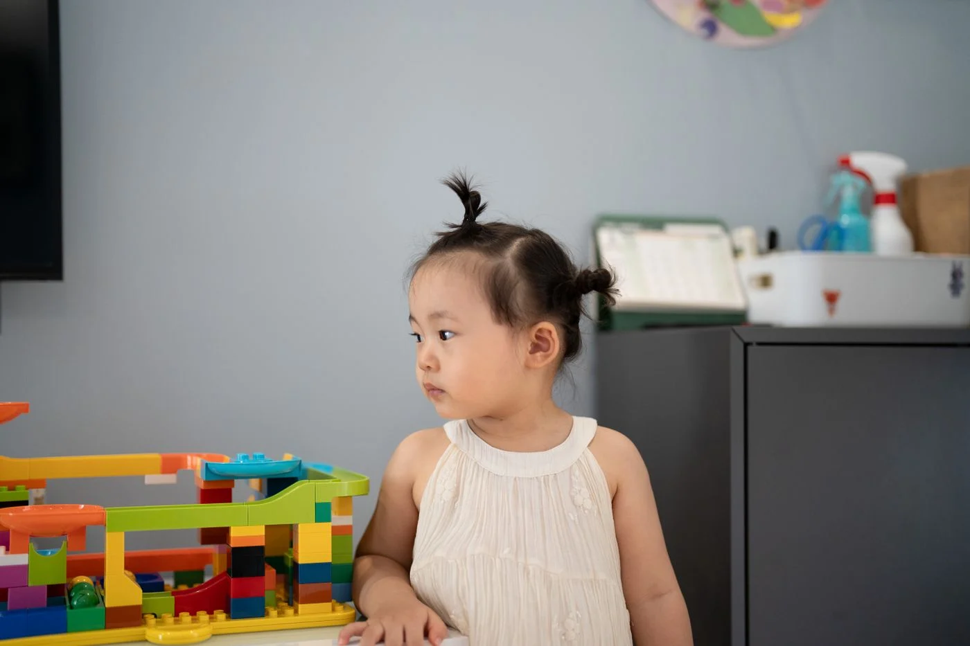 Child playing indoors with colorful building blocks