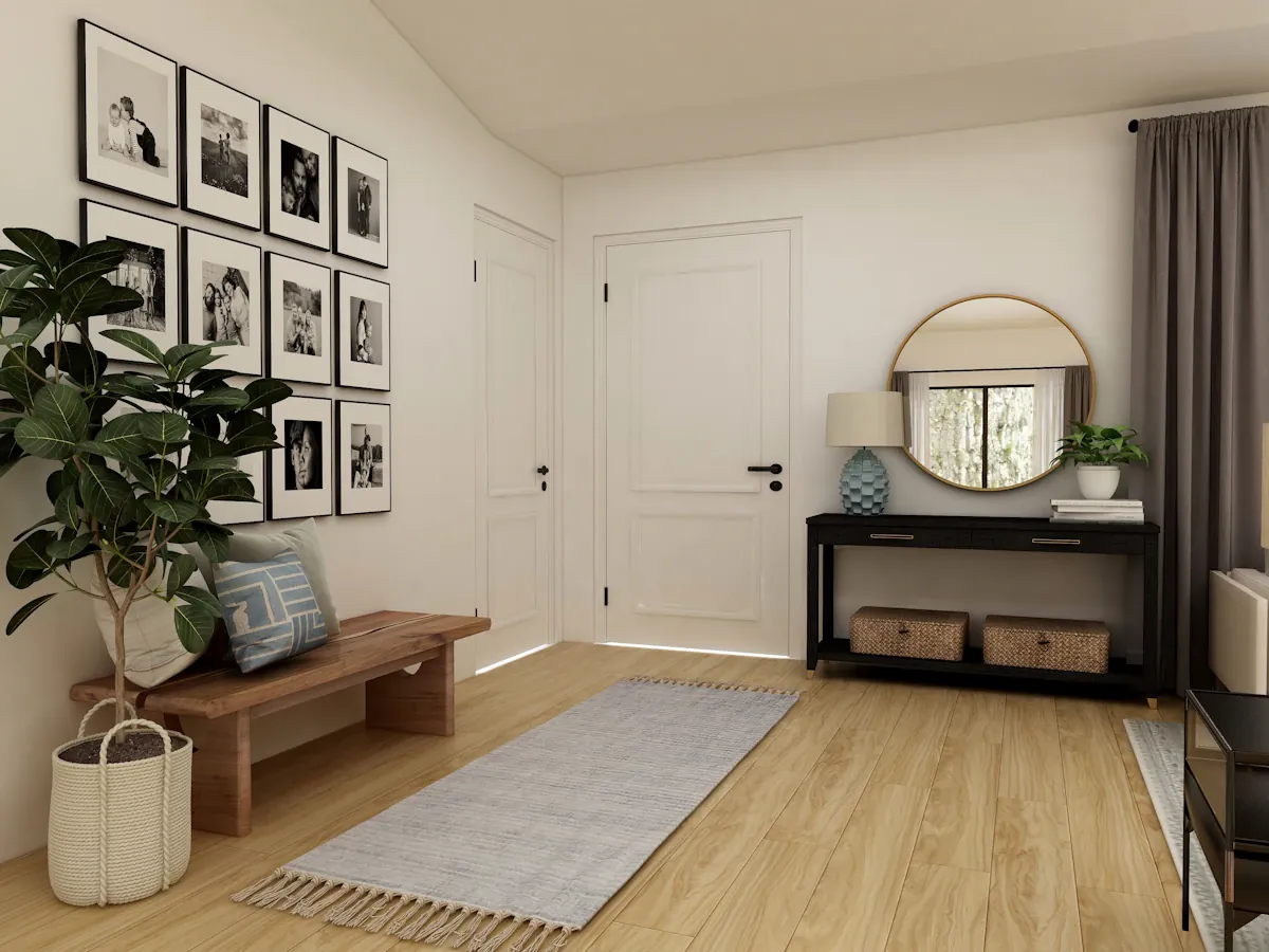 An entryway with a wooden bench, console table and round mirror