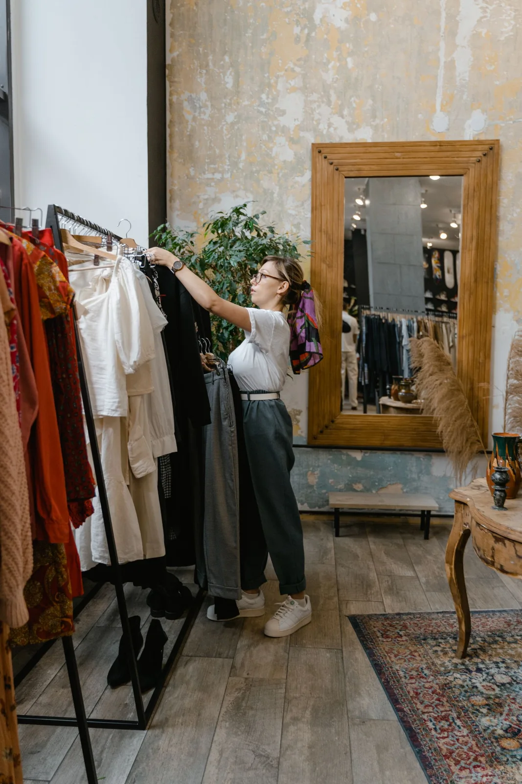 Woman browsing clothing on a rack
