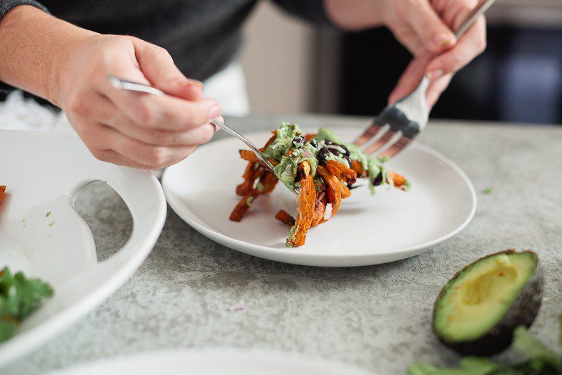 Loaded Sweet Potato Mexican Street Fries with Avocado Lime Dressing! A skinny and delicious twist on a loaded fry platter that won't mess with your waistline or derail your resolutions! Need a dinner to drool over? Try these Loaded Sweet Potato Mexican Street Fries! A skinny and delicious twist on a loaded fry platter that won't mess with your waistline or derail your resolutions! A healthy and hearty recipe from Tabitha Blue of Fresh Mommy Blog with Horizon.