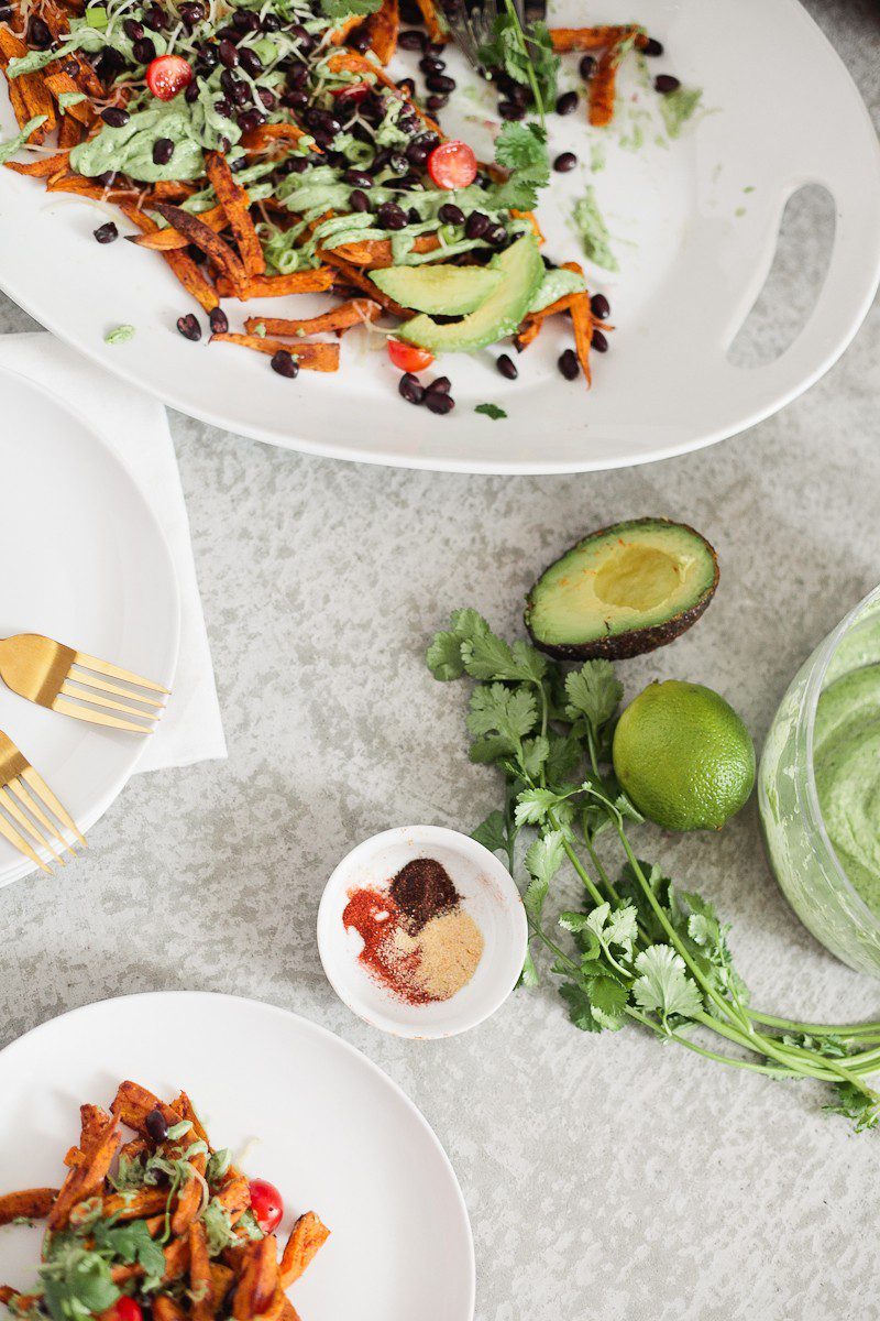 Loaded Sweet Potato Mexican Street Fries with Avocado Lime Dressing! A skinny and delicious twist on a loaded fry platter that won't mess with your waistline or derail your resolutions! Need a dinner to drool over? Try these Loaded Sweet Potato Mexican Street Fries! A skinny and delicious twist on a loaded fry platter that won't mess with your waistline or derail your resolutions! A healthy and hearty recipe from Tabitha Blue of Fresh Mommy Blog with Horizon.