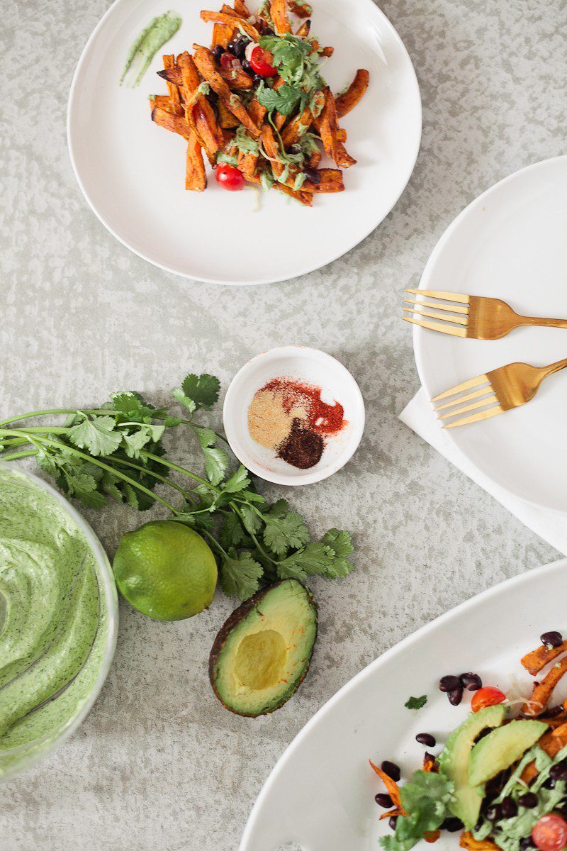 Loaded Sweet Potato Mexican Street Fries with Avocado Lime Dressing! A skinny and delicious twist on a loaded fry platter that won't mess with your waistline or derail your resolutions! Need a dinner to drool over? Try these Loaded Sweet Potato Mexican Street Fries! A skinny and delicious twist on a loaded fry platter that won't mess with your waistline or derail your resolutions! A healthy and hearty recipe from Tabitha Blue of Fresh Mommy Blog with Horizon.