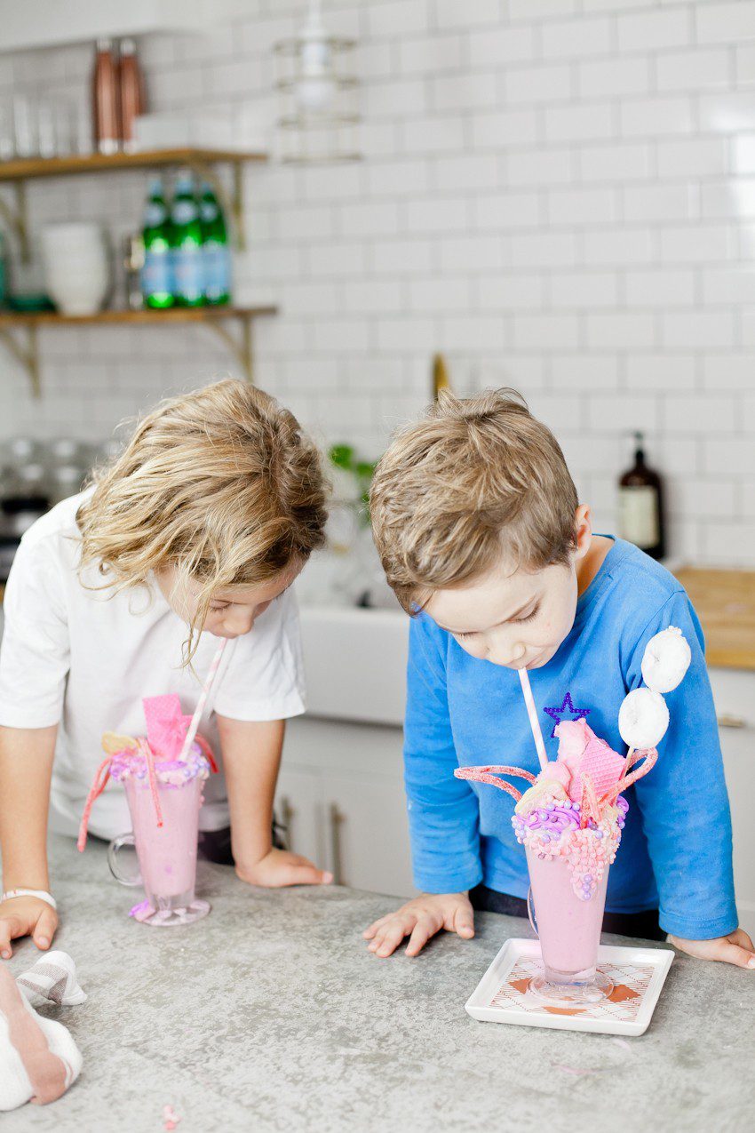 These Epic Royal Crazy shakes are indulgently MAGICAL! A rich, thick strawberry milkshake is topped with a sugaring of sprinkles and candies to make a delicious crazy shake drink fit for a princess... or a prince. A pretty in pink and purple freak shake!