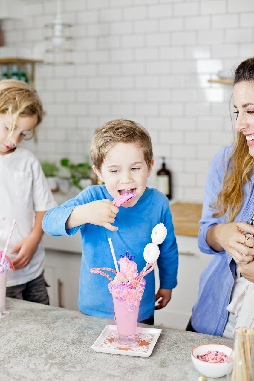 These Epic Royal Crazy shakes are indulgently MAGICAL! A rich, thick strawberry milkshake is topped with a sugaring of sprinkles and candies to make a delicious crazy shake drink fit for a princess... or a prince. A pretty in pink and purple freak shake!