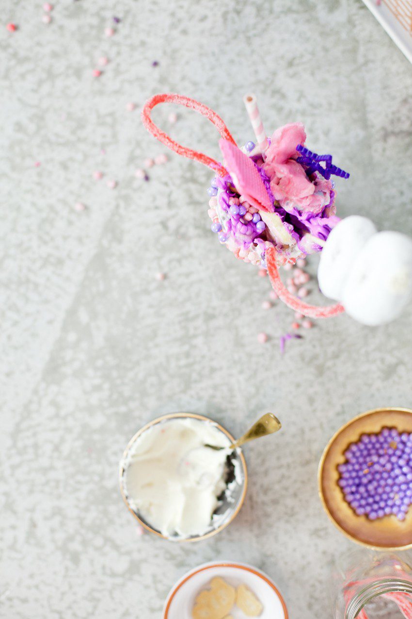 These Epic Royal Crazy shakes are indulgently MAGICAL! A rich, thick strawberry milkshake is topped with a sugaring of sprinkles and candies to make a delicious crazy shake drink fit for a princess... or a prince. A pretty in pink and purple freak shake!