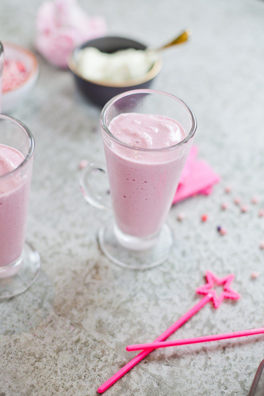These Epic Royal Crazy milkshakes are indulgently MAGICAL! A rich, thick strawberry milkshake is topped with a sugaring of sprinkles and candies to make a delicious drink fit for a princess... or a prince. A pretty in pink and purple freak shake!