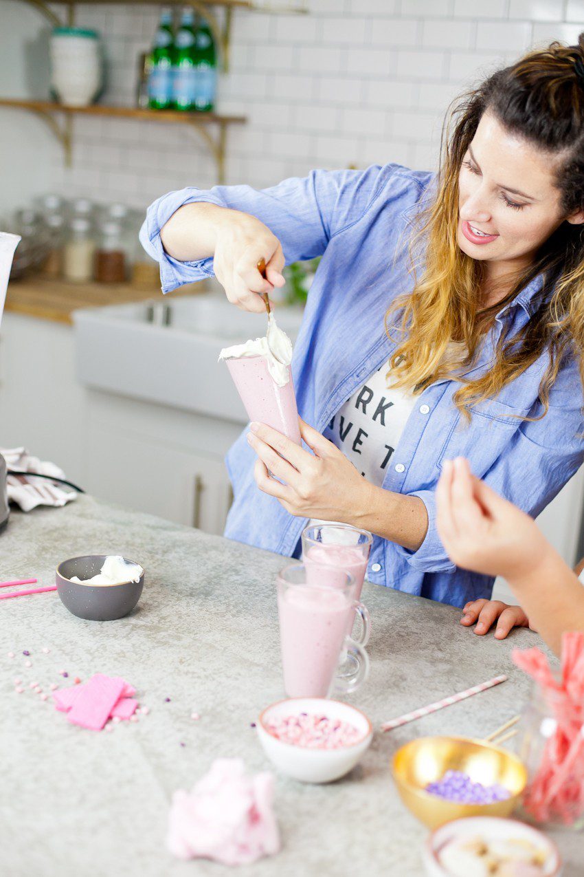 These Epic Royal Crazy milkshakes are indulgently MAGICAL! A rich, thick strawberry milkshake is topped with a sugaring of sprinkles and candies to make a delicious drink fit for a princess... or a prince. A pretty in pink and purple freak shake!