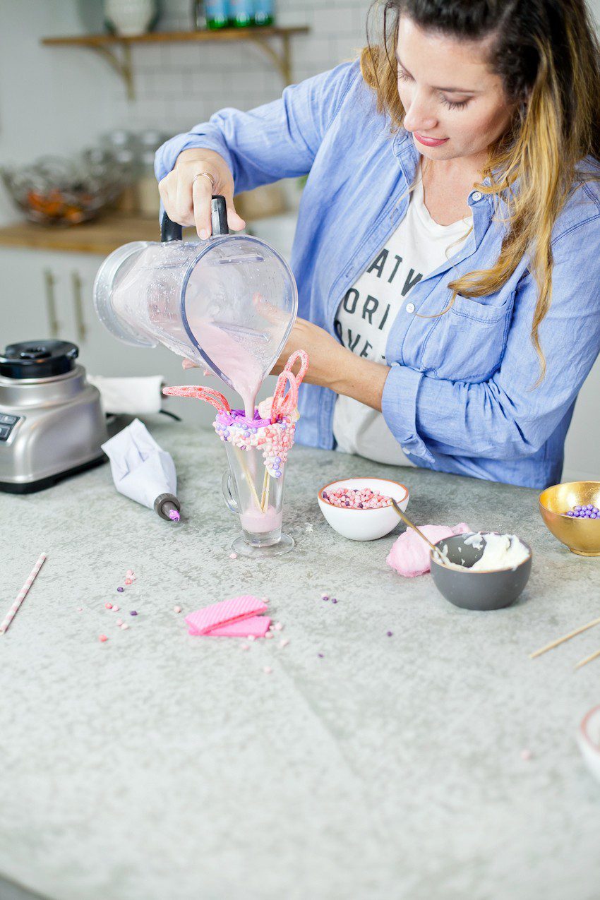 These Epic Royal Crazy milkshakes are indulgently MAGICAL! A rich, thick strawberry milkshake is topped with a sugaring of sprinkles and candies to make a delicious drink fit for a princess... or a prince. A pretty in pink and purple freak shake!