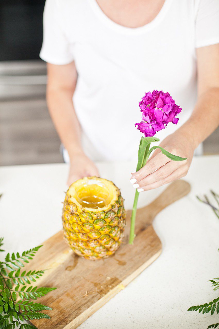Pineapple Flower Arrangement for garden parties or a summer tropical fete! This DIY Pineapple vase is an easy to make centerpiece or perfect for a Tiki bar! - Tropical Pineapple Floral Arrangement featured by popular Florida lifestyle blogger Fresh Mommy Blog