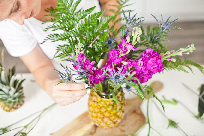 Pineapple Flower Arrangement for garden parties or a summer tropical fete! This DIY Pineapple vase is an easy to make centerpiece or perfect for a Tiki bar! - Tropical Pineapple Floral Arrangement featured by popular Florida lifestyle blogger Fresh Mommy Blog