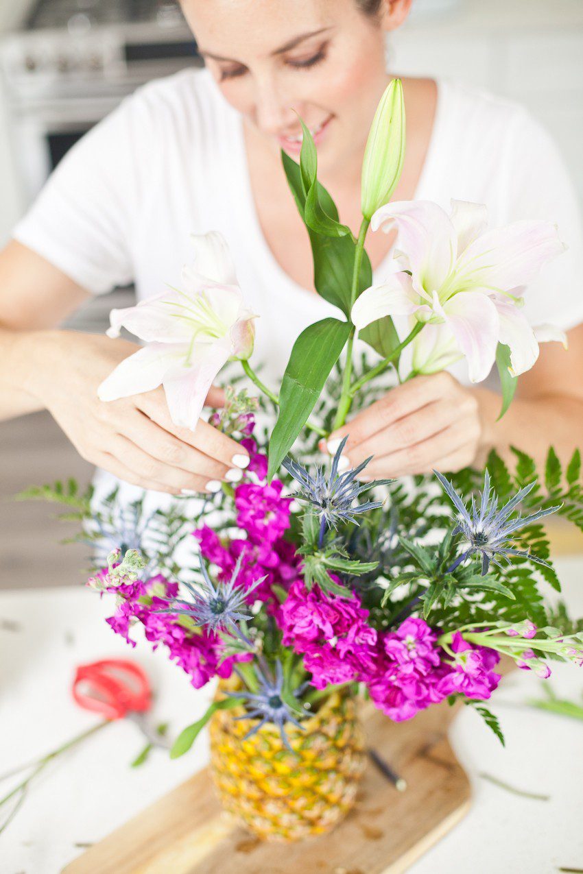 Pineapple Flower Arrangement for garden parties or a summer tropical fete! This DIY Pineapple vase is an easy to make centerpiece or perfect for a Tiki bar! - Tropical Pineapple Floral Arrangement featured by popular Florida lifestyle blogger Fresh Mommy Blog