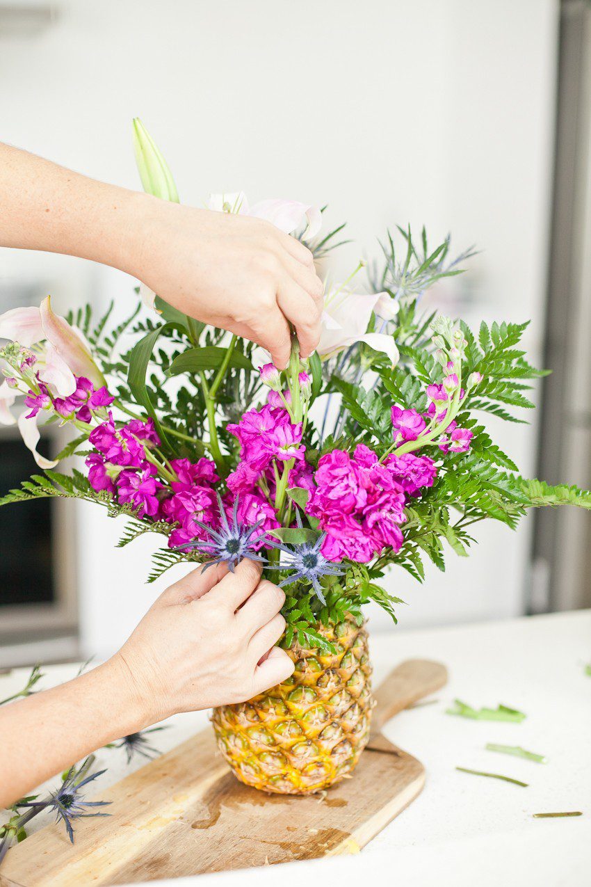 Pineapple Flower Arrangement for garden parties or a summer tropical fete! This DIY Pineapple vase is an easy to make centerpiece or perfect for a Tiki bar! - Tropical Pineapple Floral Arrangement featured by popular Florida lifestyle blogger Fresh Mommy Blog