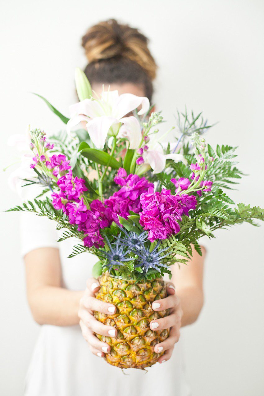 Pineapple Flower Arrangement for garden parties or a summer tropical fete! This DIY Pineapple vase is an easy to make centerpiece or perfect for a Tiki bar! - Tropical Pineapple Floral Arrangement featured by popular Florida lifestyle blogger Fresh Mommy Blog