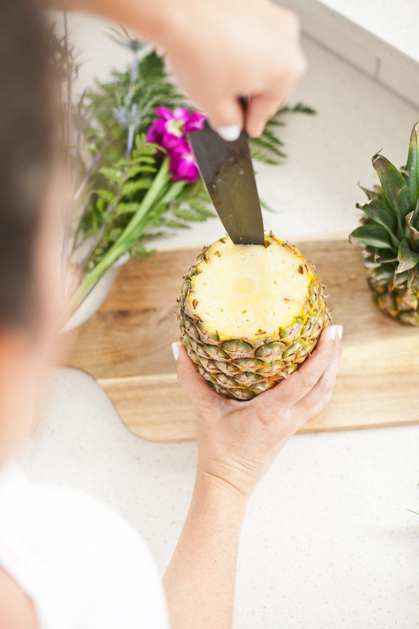 Pineapple Flower Arrangement for garden parties or a summer tropical fete! This DIY Pineapple vase is an easy to make centerpiece or perfect for a Tiki bar! - Tropical Pineapple Floral Arrangement featured by popular Florida lifestyle blogger Fresh Mommy Blog