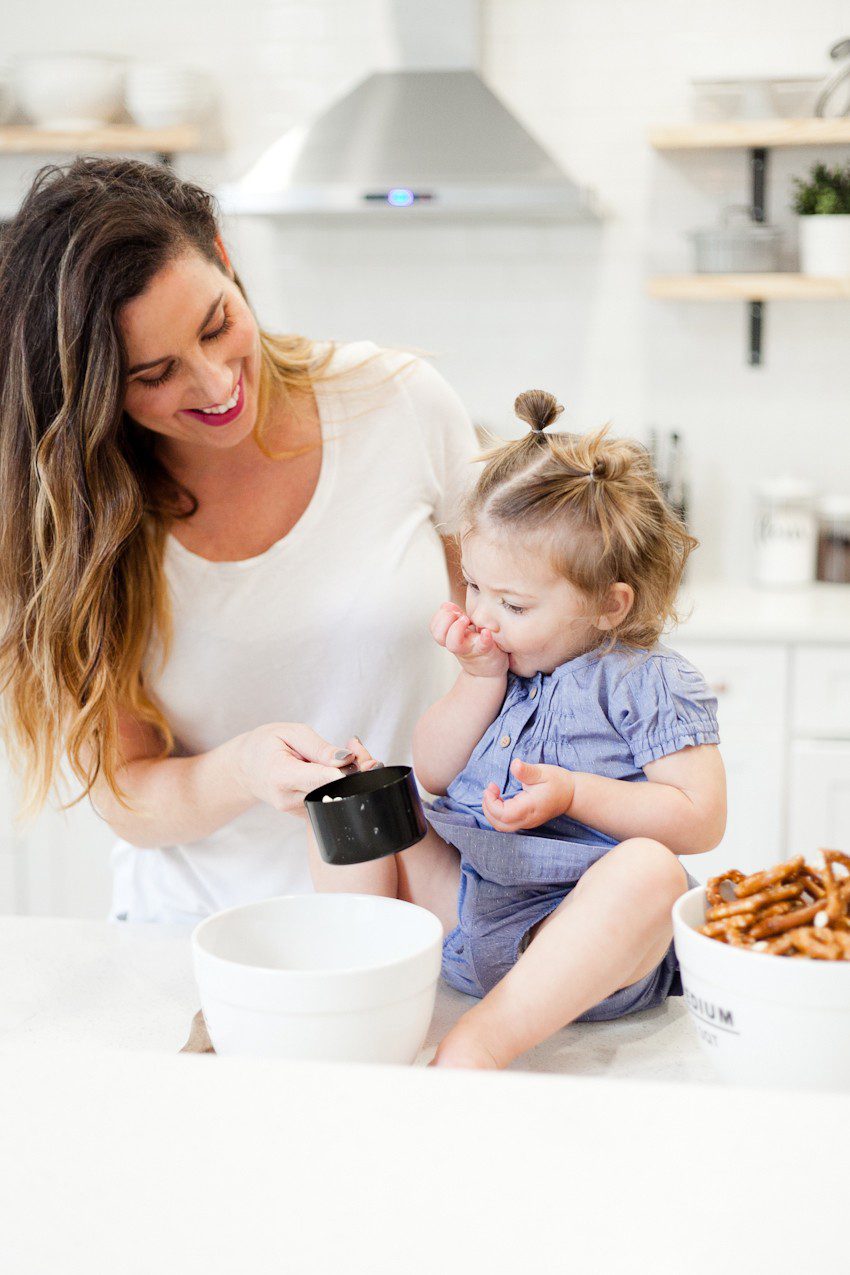 A simple and easy Valentine's Day chocolate dipped pretzels treat, that you can make with and for your kids (they look like they took more effort than they really do!), by Tabitha Blue of Fresh Mommy Blog - Valentines Day Lovely Chocolate Dipped Pretzels by popular Florida lifestyle blogger Fresh Mommy Blog