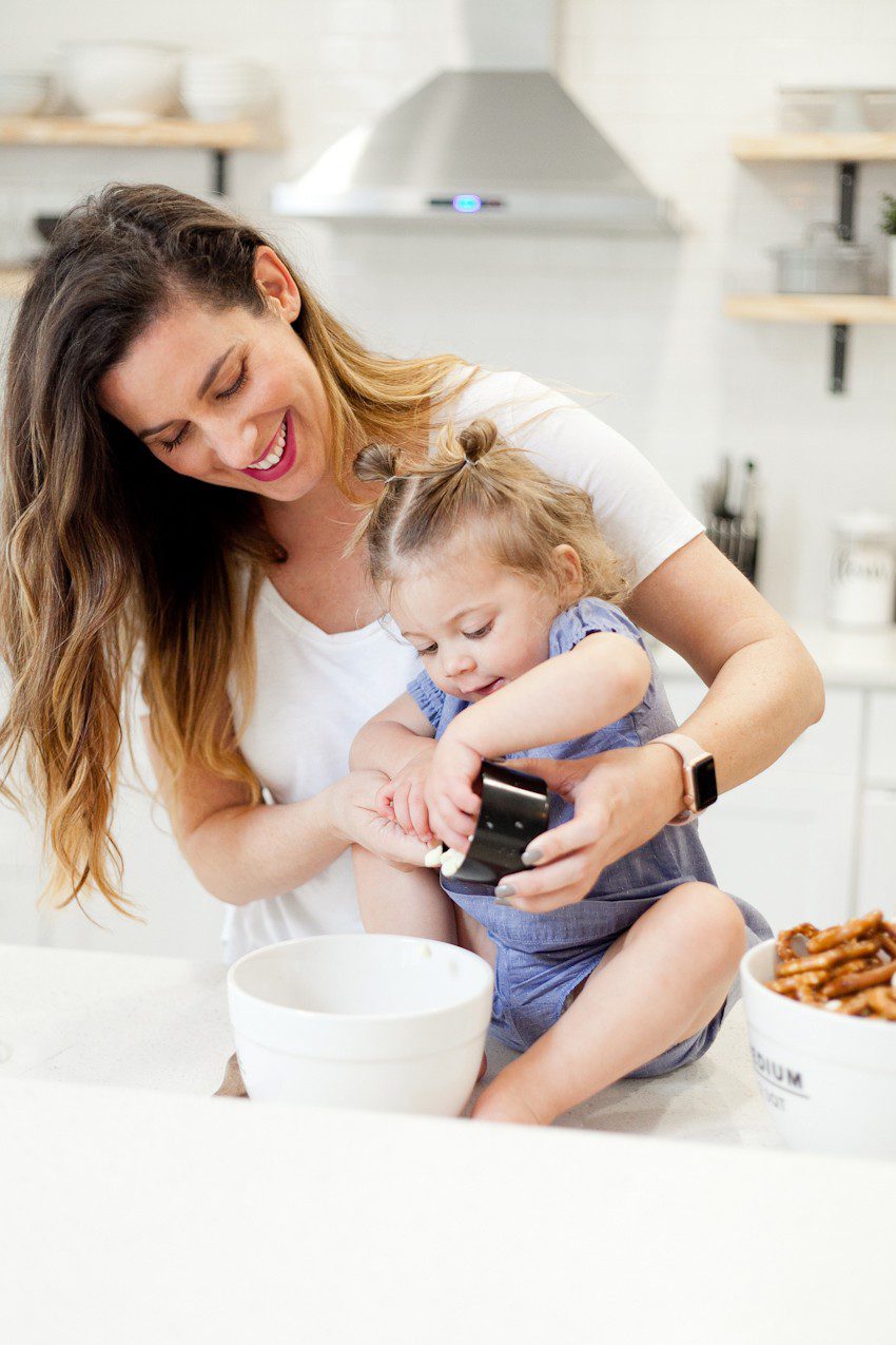 A simple and easy Valentine's Day chocolate dipped pretzels treat, that you can make with and for your kids (they look like they took more effort than they really do!), by Tabitha Blue of Fresh Mommy Blog - Valentines Day Lovely Chocolate Dipped Pretzels by popular Florida lifestyle blogger Fresh Mommy Blog