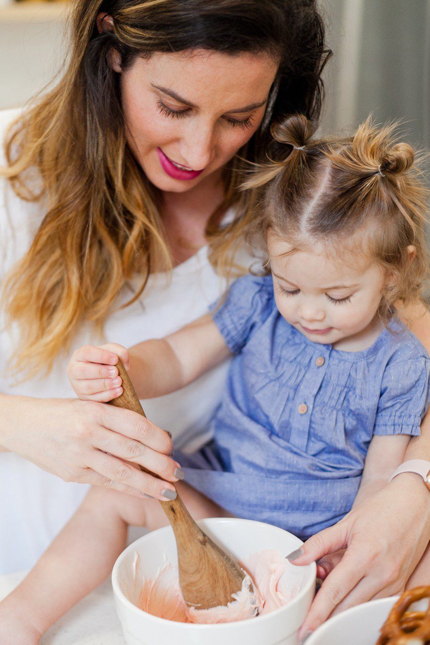 A simple and easy Valentine's Day chocolate dipped pretzels treat, that you can make with and for your kids (they look like they took more effort than they really do!), by Tabitha Blue of Fresh Mommy Blog - Valentines Day Lovely Chocolate Dipped Pretzels by popular Florida lifestyle blogger Fresh Mommy Blog