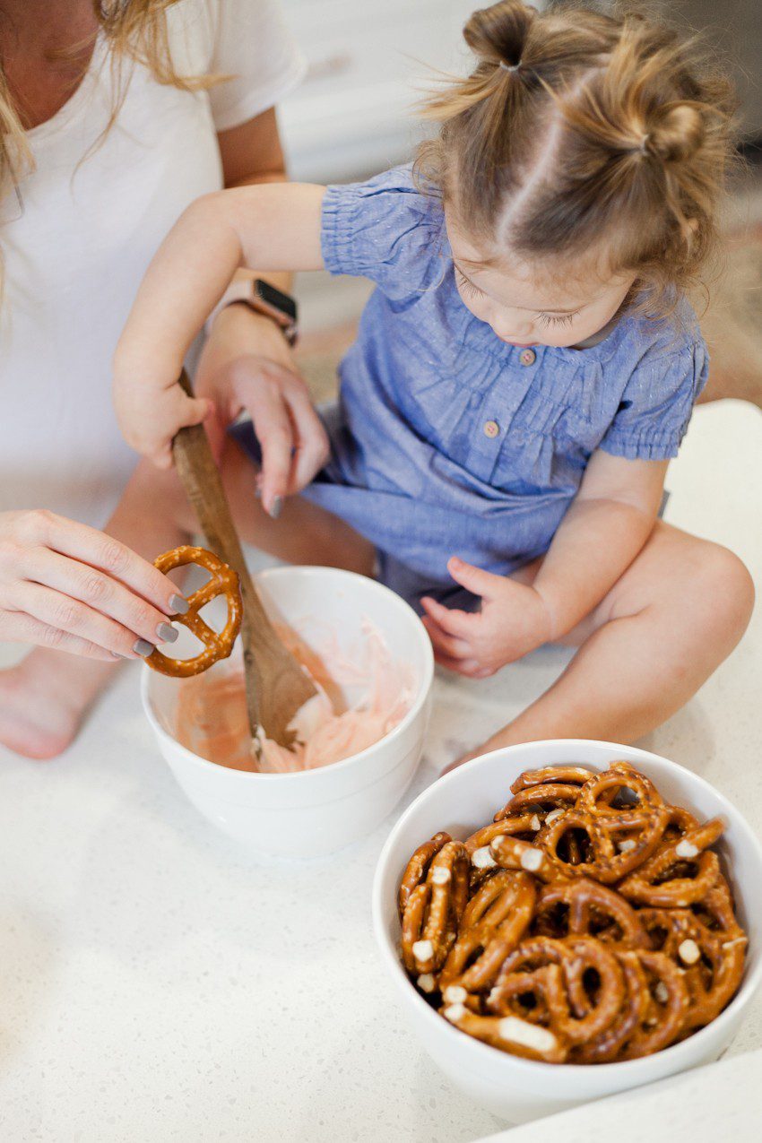 A simple and easy Valentine's Day chocolate dipped pretzels treat, that you can make with and for your kids (they look like they took more effort than they really do!), by Tabitha Blue of Fresh Mommy Blog - Valentines Day Lovely Chocolate Dipped Pretzels by popular Florida lifestyle blogger Fresh Mommy Blog