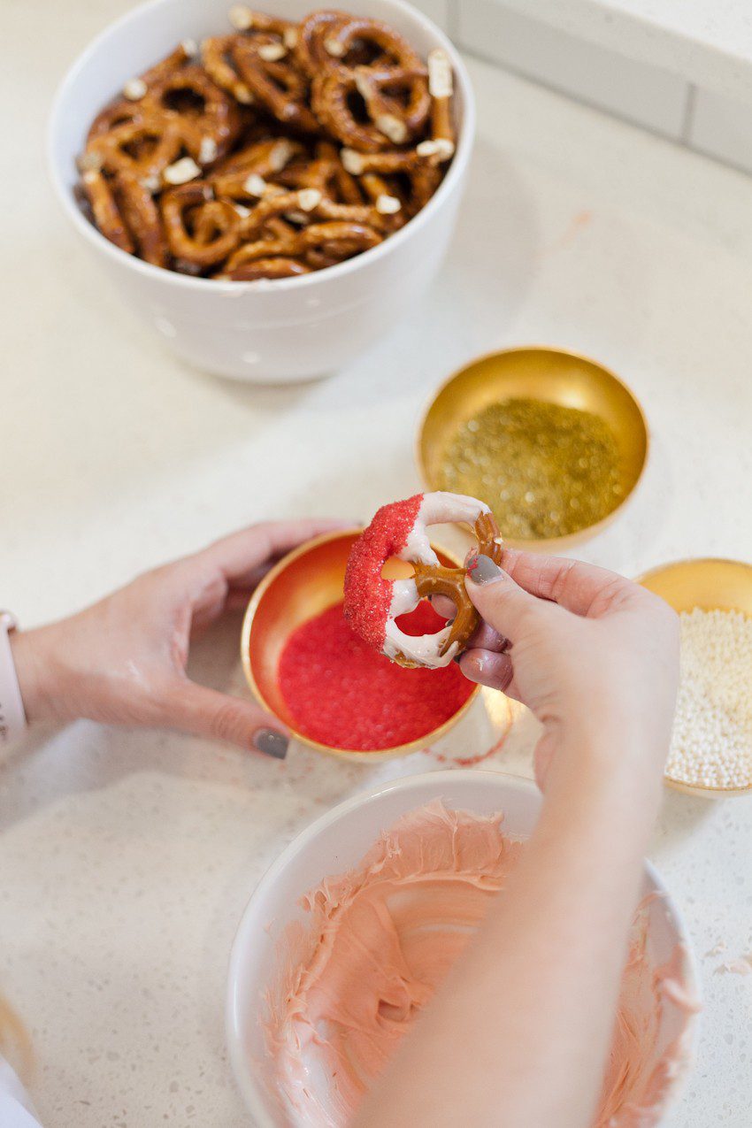 A simple and easy Valentine's Day chocolate dipped pretzels treat, that you can make with and for your kids (they look like they took more effort than they really do!), by Tabitha Blue of Fresh Mommy Blog - Valentines Day Lovely Chocolate Dipped Pretzels by popular Florida lifestyle blogger Fresh Mommy Blog