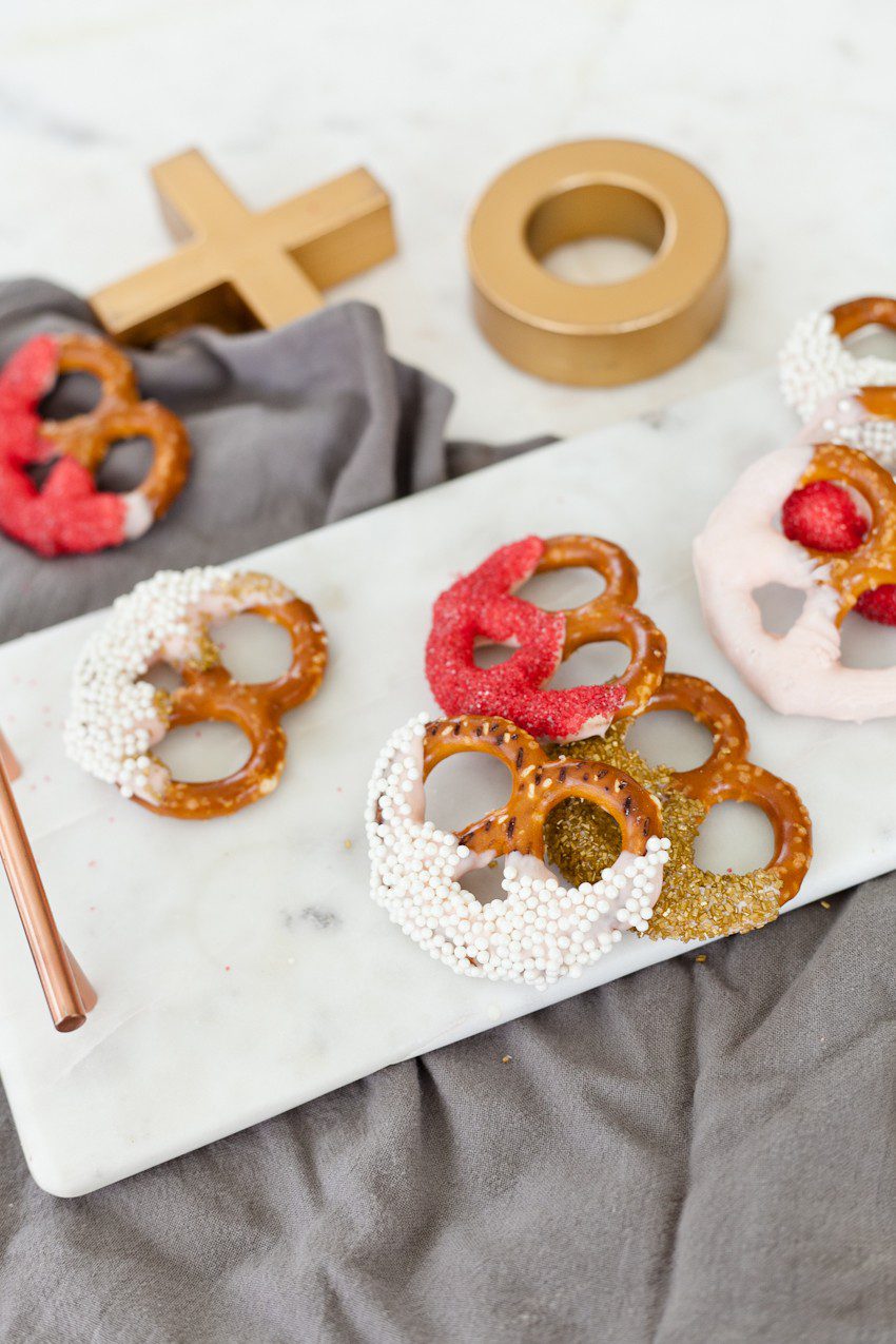 A simple and easy Valentine's Day chocolate dipped pretzels treat, that you can make with and for your kids (they look like they took more effort than they really do!), by Tabitha Blue of Fresh Mommy Blog - Valentines Day Lovely Chocolate Dipped Pretzels by popular Florida lifestyle blogger Fresh Mommy Blog