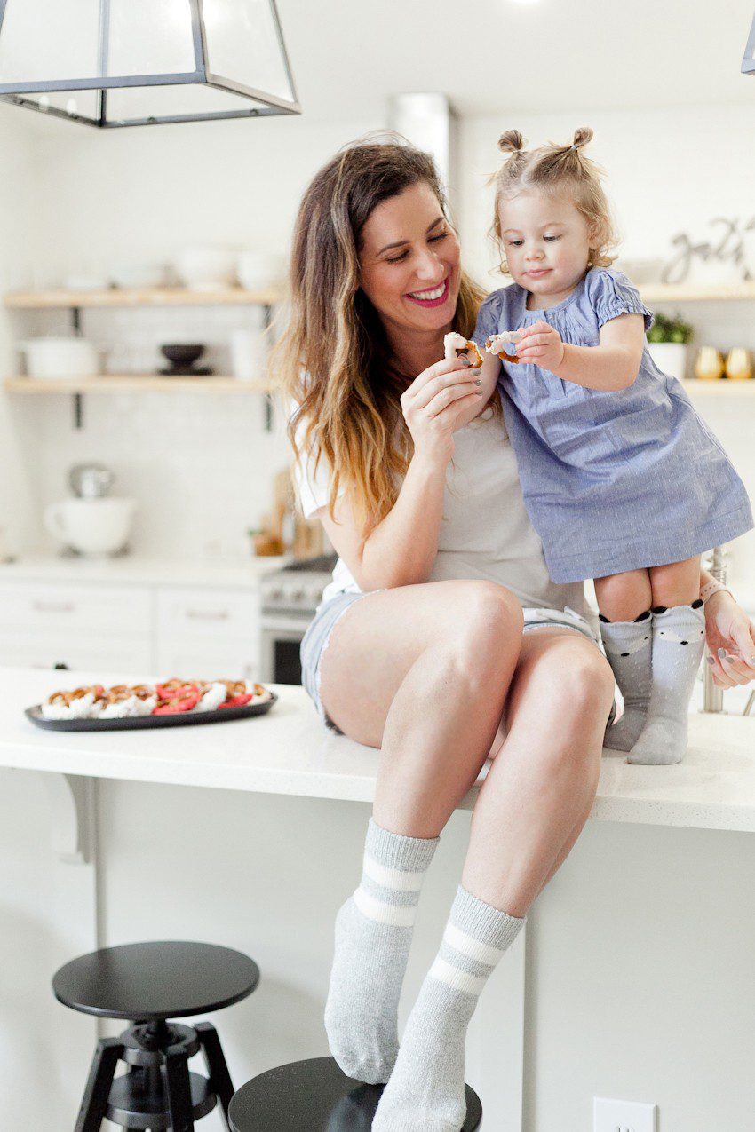 A simple and easy Valentine's Day chocolate dipped pretzels treat, that you can make with and for your kids (they look like they took more effort than they really do!), by Tabitha Blue of Fresh Mommy Blog - Valentines Day Lovely Chocolate Dipped Pretzels by popular Florida lifestyle blogger Fresh Mommy Blog