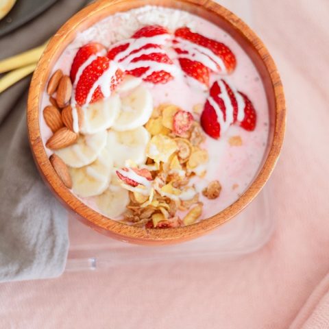 Valentine's Day Breakfast in Bed full of all things sweet, pink and delicious, of course! Heart waffles and strawberries and cream smoothie bowl, that tastes like ice cream, steal the show in this morning breakfast tray styled for your valentine.