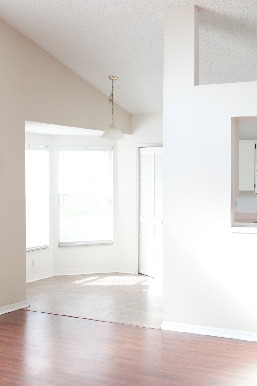 Before and After Kitchen Makeover DIY in this House to Home episode with popular Florida blogger Tabitha Blue. Pairing white cabinets with classic subway tile, rustic open shelving, gray island with copper apron sink and more DIY kitchen makeover details.
