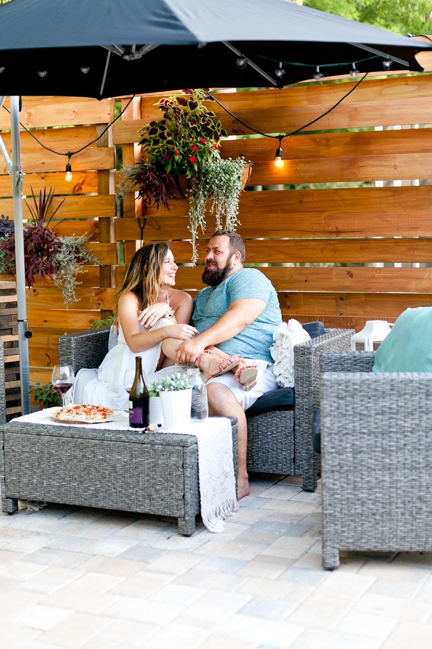 Salt water pool conversion guide featured by top Florida home blog, Fresh Mommy Blog | Hayward Aqua Rite Salt Chlorine Generator by popular Florida lifestyle blog, Fresh Mommy Blog: image of a man and woman sitting together on some patio furniture and talking. 