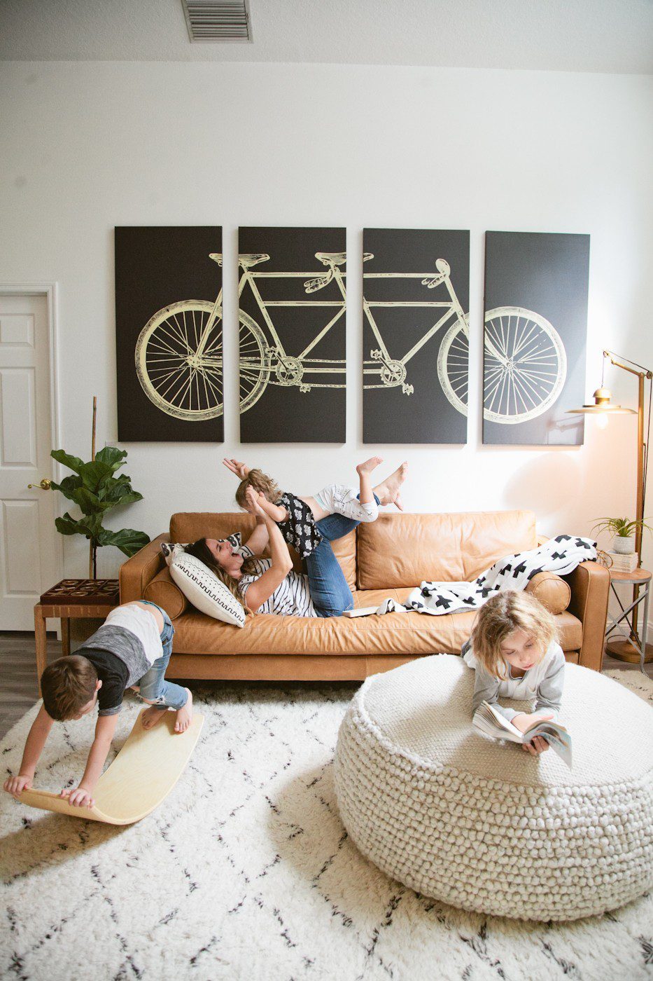 Seeing past dated paint colors, a wall of mirrors, popcorn ceiling and mismatched flooring, this ultimate living room has been completely transformed to a cozy and comfortable open family living space with bold statement pieces like our Article sofa, neutral colors and touches of sleek mid century and Scandinavian inspired design. The ultimate living room makeover before and after for a busy family from popular Florida lifestyle blogger Tabitha Blue of Fresh Mommy Blog. | Article sofa featured in the latest living room makeover by top Florida lifestyle blog, Fresh Mommy Blog