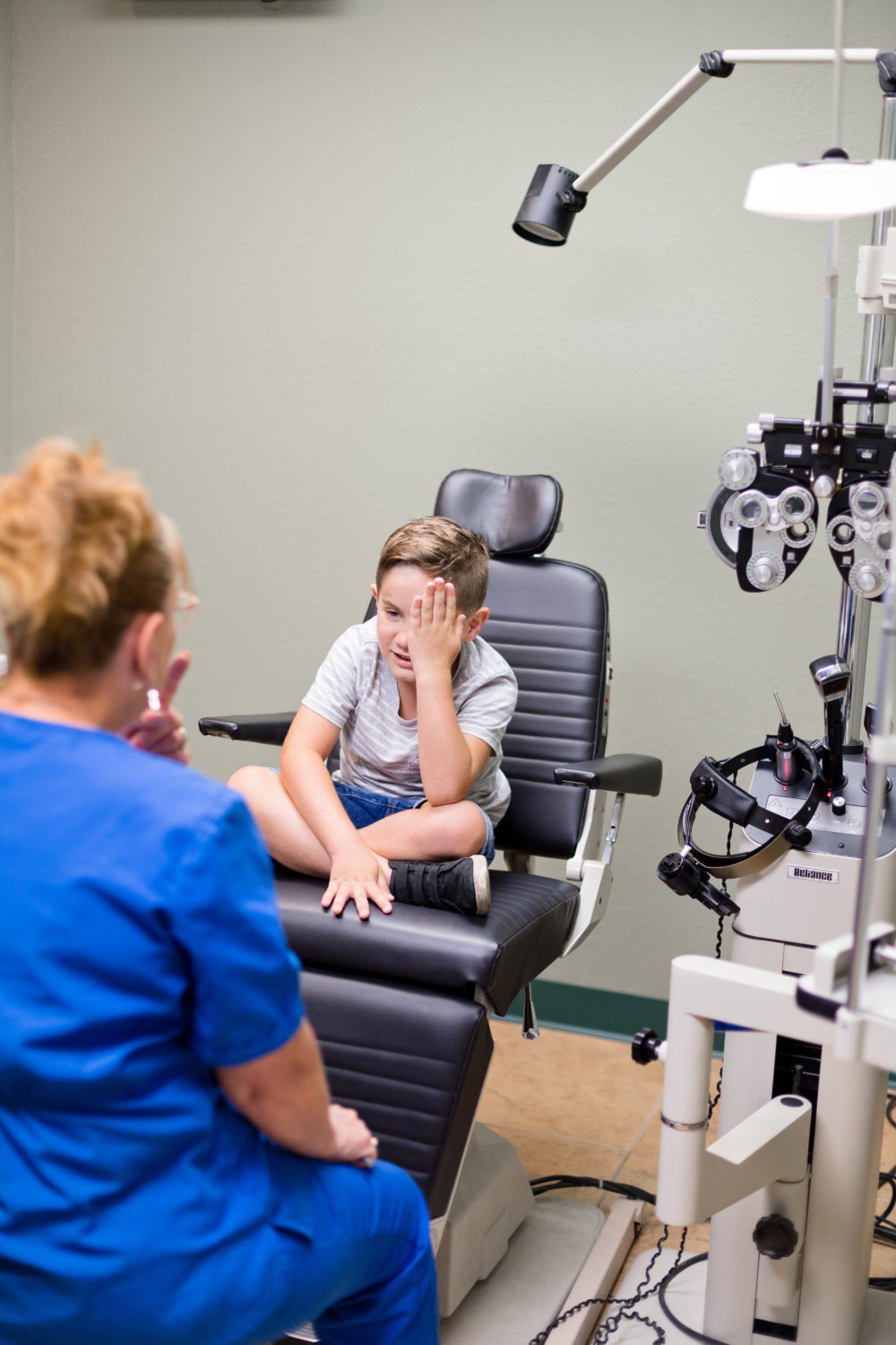 Back to School Eye Exam: How to Prepare your Child for a Successful Academic Year | Back to School Eye Exam: How to Prepare your Child for a Successful Academic Year by popular Florida lifestyle blog, Fresh Mommy Blog: image of a young boy getting his eyes examined.