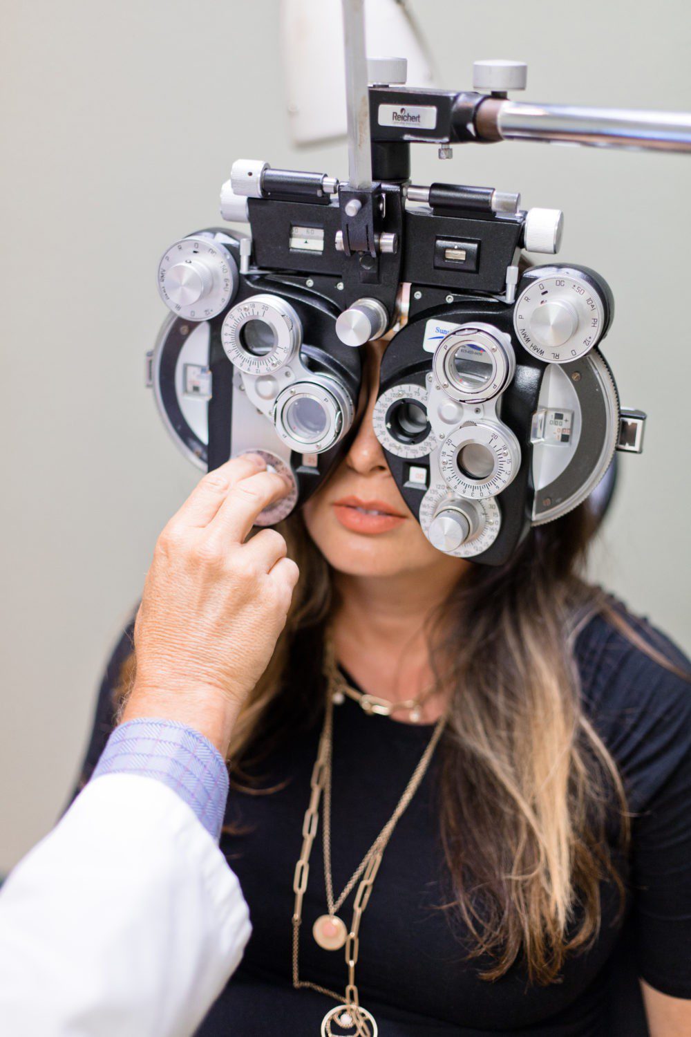 Back to School Eye Exam: How to Prepare your Child for a Successful Academic Year | Back to School Eye Exam: How to Prepare your Child for a Successful Academic Year by popular Florida lifestyle blog, Fresh Mommy Blog: image of a woman getting her eyes examined by an eye doctor.