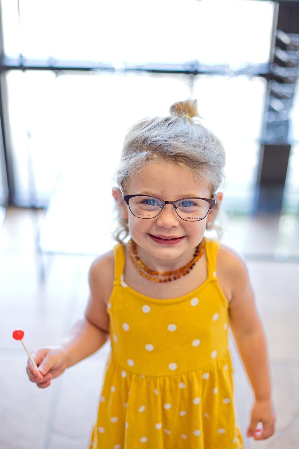 Back to School Eye Exam: How to Prepare your Child for a Successful Academic Year | Back to School Eye Exam: How to Prepare your Child for a Successful Academic Year by popular Florida lifestyle blog, Fresh Mommy Blog: image of a young girl wearing a pair of glasses.
