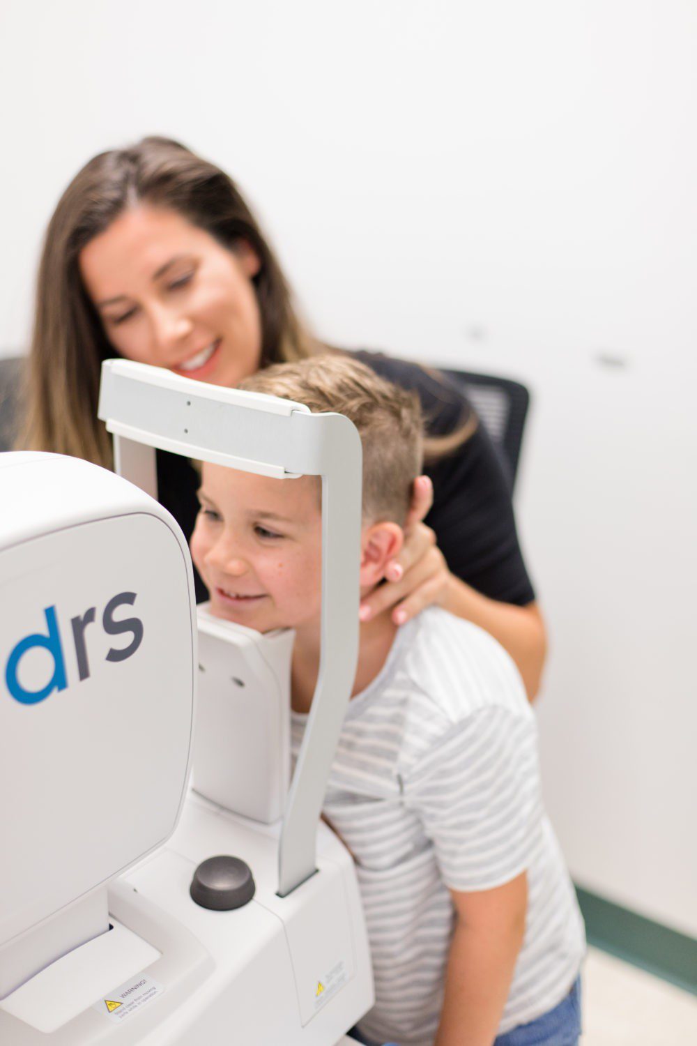 Back to School Eye Exam: How to Prepare your Child for a Successful Academic Year | Back to School Eye Exam: How to Prepare your Child for a Successful Academic Year by popular Florida lifestyle blog, Fresh Mommy Blog: image of a young boy getting his eyes examined.