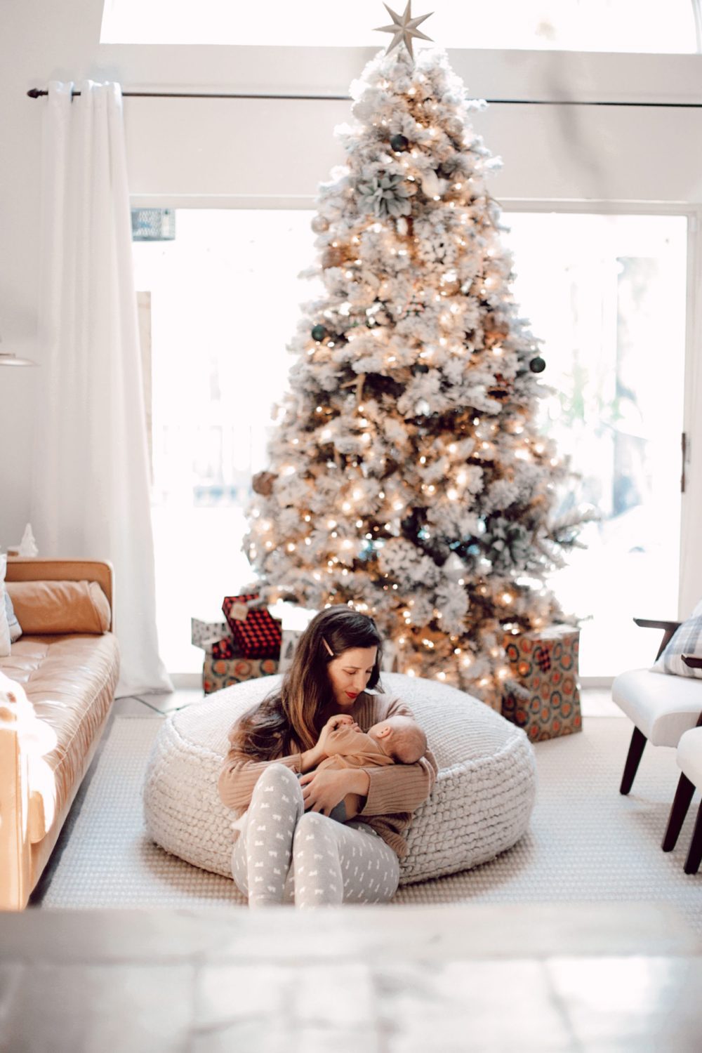 7 Geniously Efficient Mom Hacks for Home Design | 7 Genius Efficient Home Design Hacks for Moms by popular Florida life and style blog, Fresh Mommy Blog: image of a mom sitting on the floor in her living room and holding her new born baby.7 Genius Efficient Home Design Hacks for Moms by popular Florida life and style blog, Fresh Mommy Blog: image of a mom sitting on the floor in her living room and holding her new born baby.