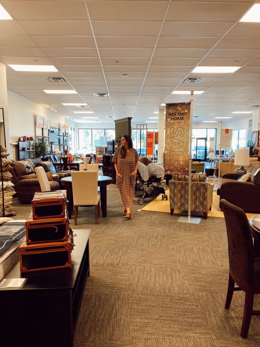 7 Geniously Efficient Mom Hacks for Home Design | 7 Genius Efficient Home Design Hacks for Moms by popular Florida life and style blog, Fresh Mommy Blog: image of a mom walking through CORT furniture outlet.