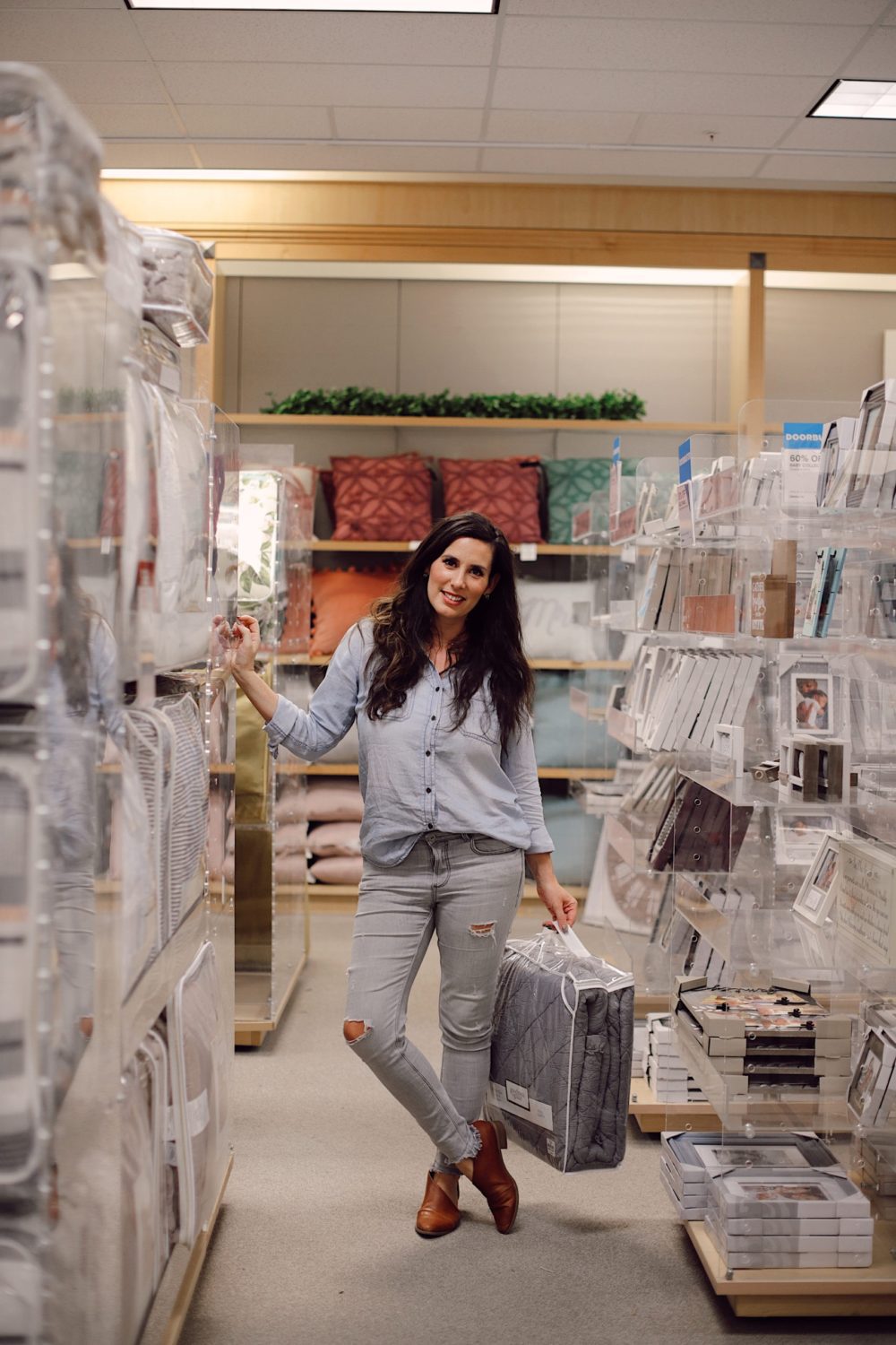 how to Make your Bed Comfortable Like a Hotel in 7 Easy Steps, a tutorial featured by top Florida lifestyle blog, Fresh Mommy Blog. | Best Bedding by popular Florida life and style blog, Fresh Mommy: image of a woman standing in a bedding aisle. 