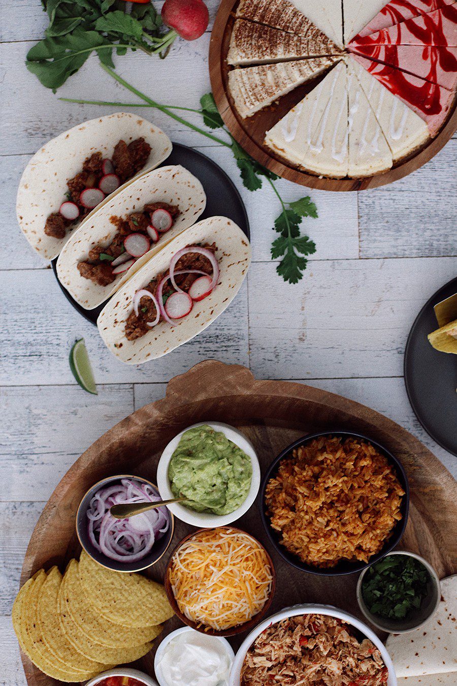 How to make an epic taco board and taco party platter tips! Plus, the best slow cooker taco chicken recipe! | Chicken Tacos by popular Florida lifestyle blog, Fresh Mommy Blog: image of pork barbacoa tacos, chicken taco platter, and cheesecake sampler. 