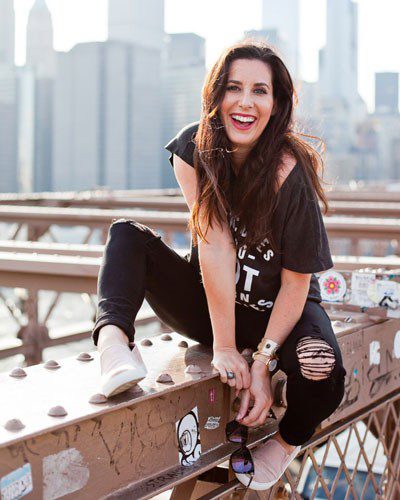 woman sitting on Brooklyn Bridge